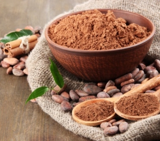 Image of cocoa beans with bowl of cocoa powder